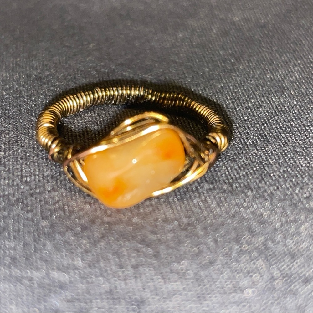 Copper wire ring with orange stone.